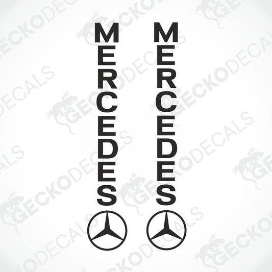 Two black decals with the word 'MERCEDES' on each, with the Mercedes-Benz logo in the center of each decal.