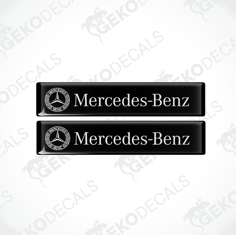 Two black vinyl stickers with the Mercedes-Benz logo printed on them.