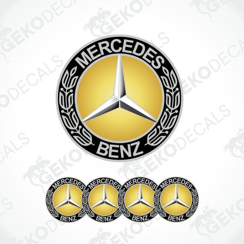 A set of four vinyl decals with a polyurethane coating featuring the Mercedes-Benz logo in gold, black, and silver colors.
