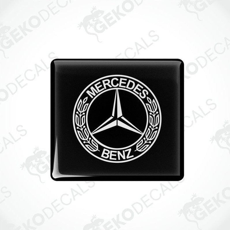 Two black square decals with the Mercedes-Benz logo in white.