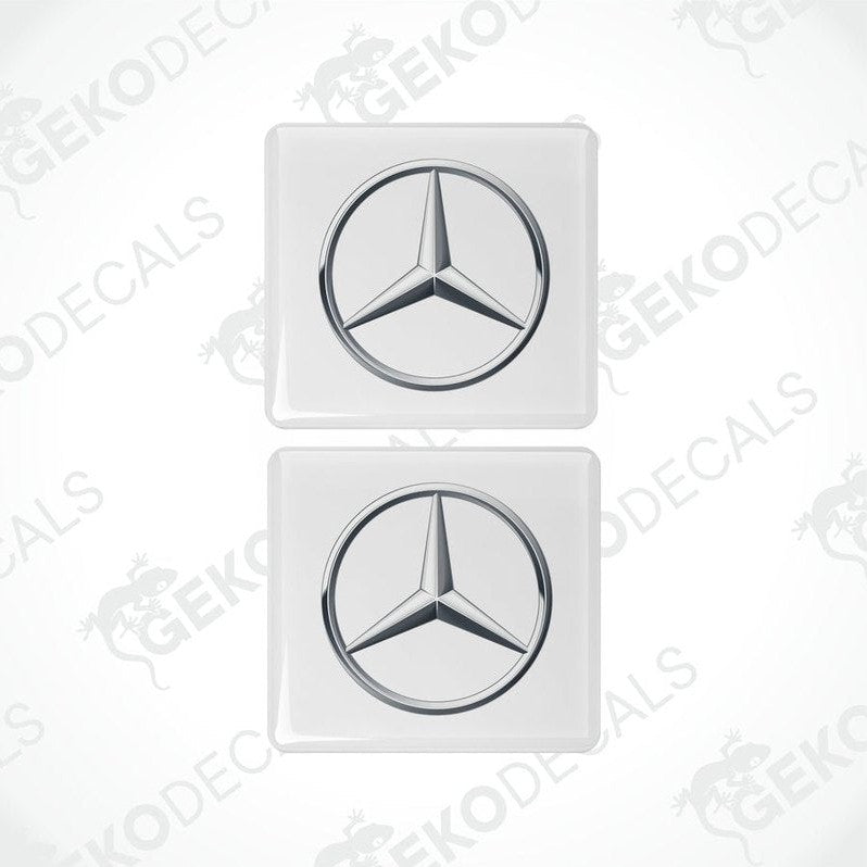 Two white vinyl stickers with a Mercedes-Benz logo on a white background.