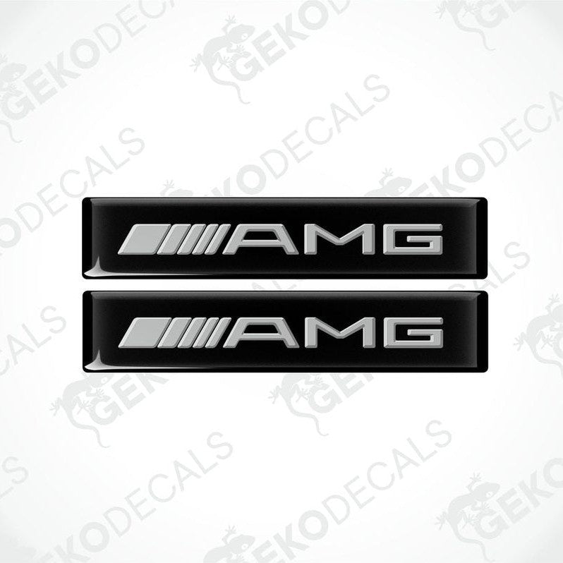 Two black vinyl stickers with the Mercedes-Benz AMG logo on a white background.