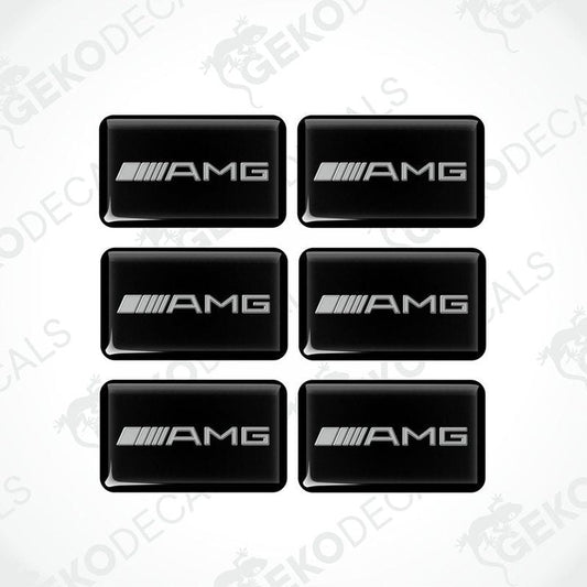 A set of six black rectangular car decals with the AMG logo in grey.
