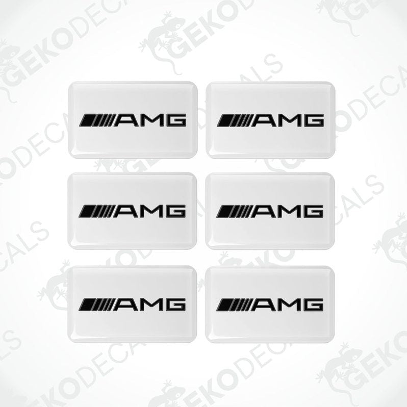 A set of six withe rectangular car decals with the AMG logo in black.