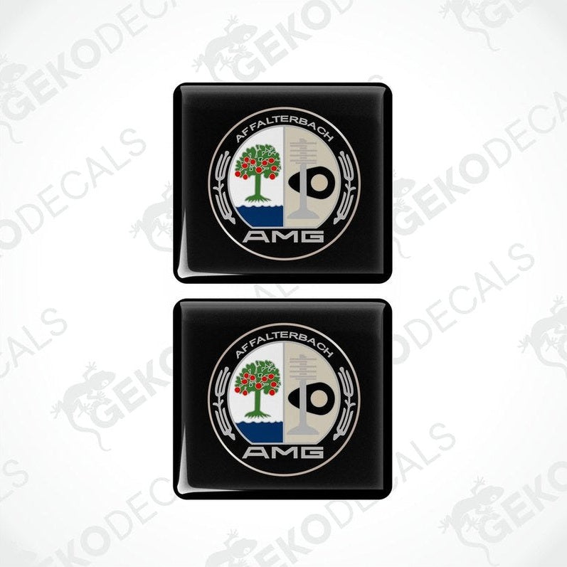 Two black square car decals with a white and green emblem AMG AFFALTERBACH
