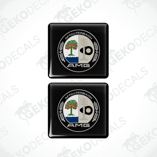 Two black square car decals with a white and green emblem AMG AFFALTERBACH
