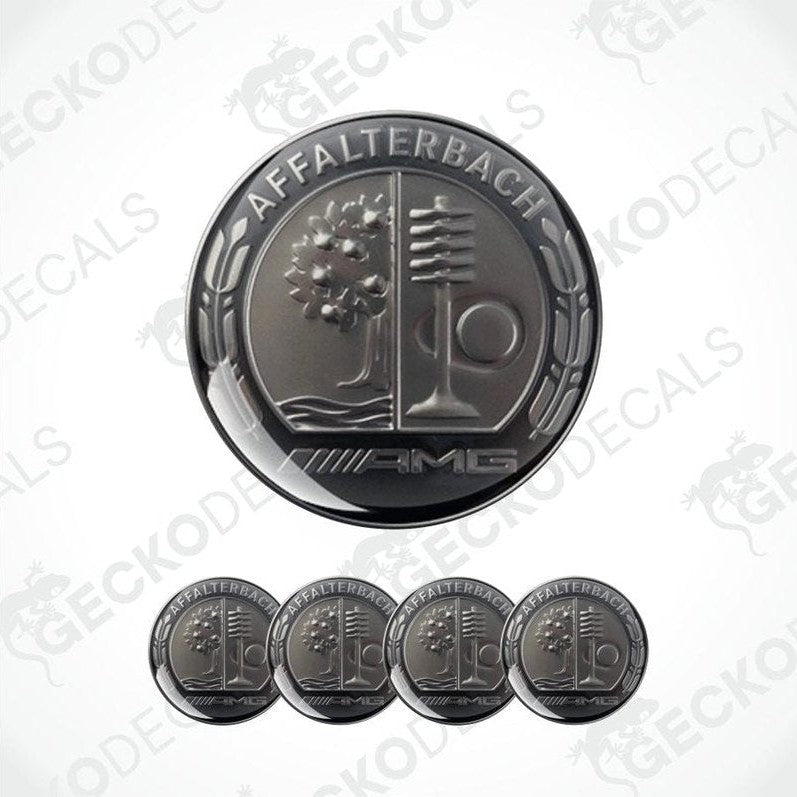 Set of metallic emblem stickers with 'AMG' branding on a white background.