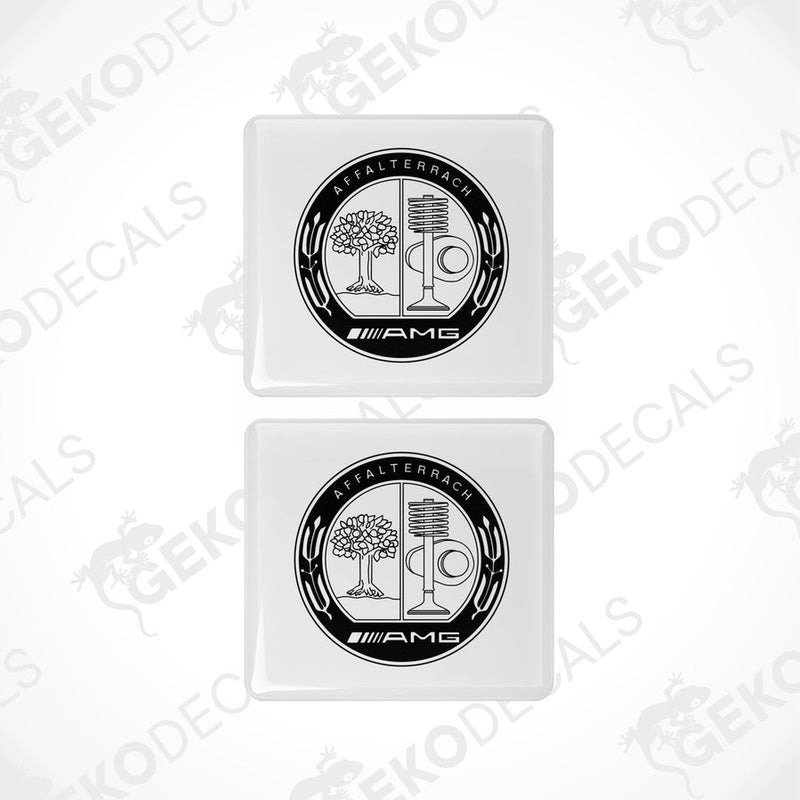 Two white vinyl stickers with a black and silver Mercedes-Benz AMG Affalterbach logo design.