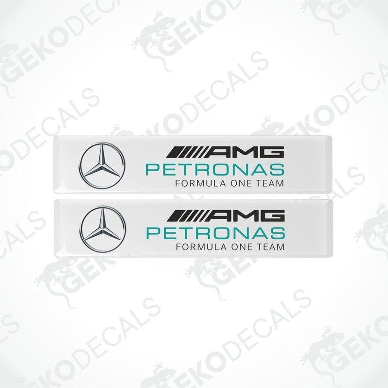 Two vinyl decals with a polyurethane coating featuring the AMG PETRONAS Formula One Team logo in white, silver, and green colors.