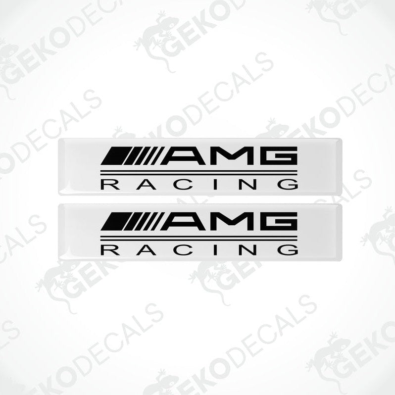 Two white vinyl stickers with the text 'AMG RACING' in white, placed against a black background.