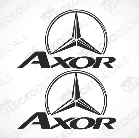 Two white decals of the Mercedes-Benz Axor brand, with one featuring the logo on a shield-like background and the other having the text 'AXOR' below it.