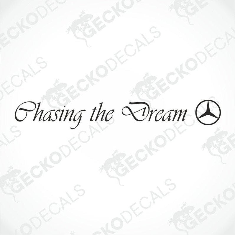 A die cut decal with the phrase 'Chasing the Dream' placed on the windscreen of a gray Mercedes-Benz truck.