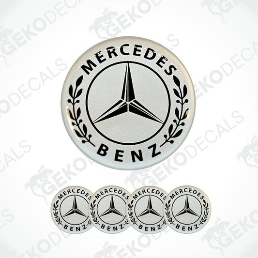 A set of white vinyl decals with the Mercedes-Benz logo, including one larger decal with leaf patterns around the star and four smaller ones.
