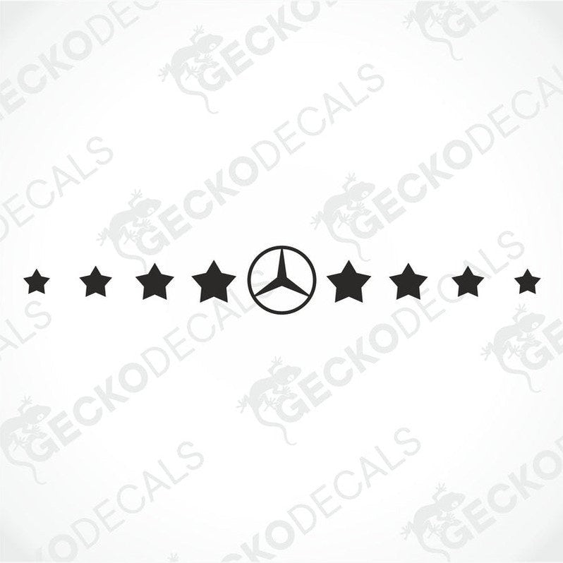 A front view of a truck windscreen with a decal of stars in a pattern across the top. The truck is gray, and the decal is black, creating a contrast.