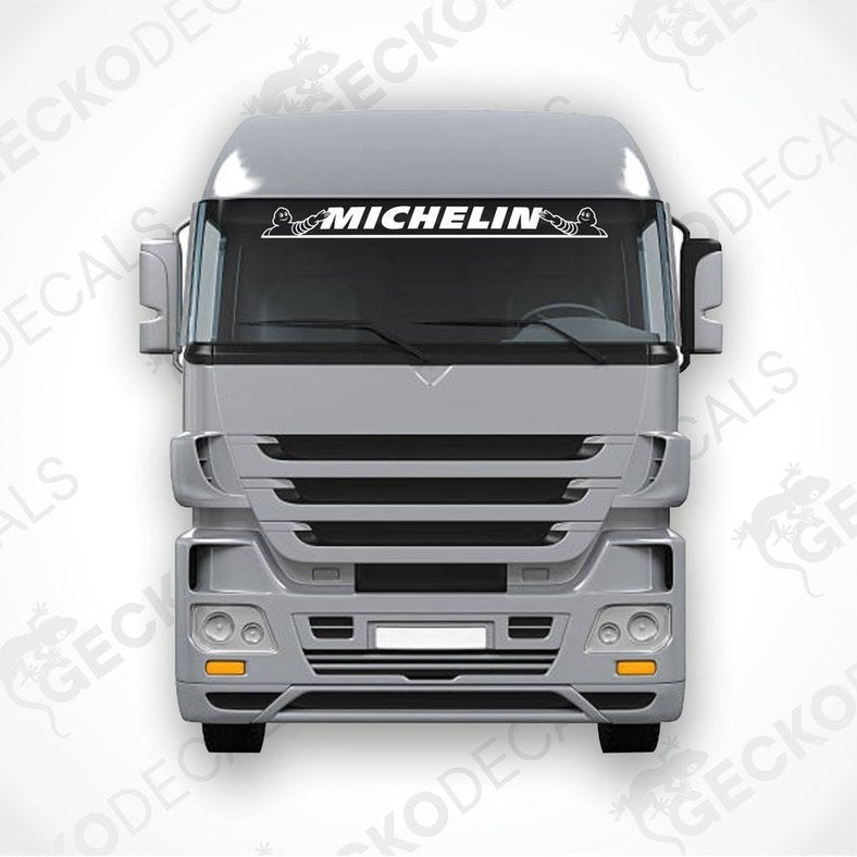 A die cut decal with the Michelin logo displayed on the windshield of a gray truck. The decal is designed for use on both interior and exterior surfaces.