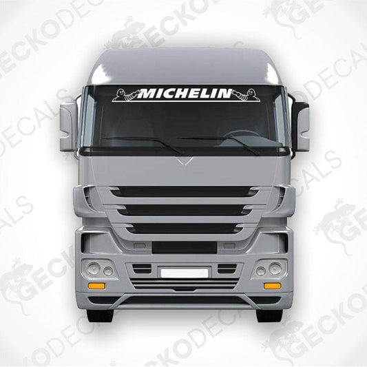 A die cut decal with the Michelin logo displayed on the windshield of a gray truck. The decal is designed for use on both interior and exterior surfaces.