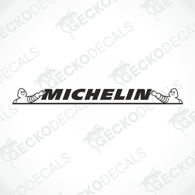 A die cut decal with the Michelin logo displayed on the windshield of a gray truck. The decal is designed for use on both interior and exterior surfaces.