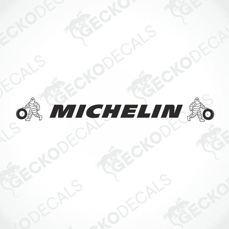 A die cut decal with the Michelin logo applied on the windscreen of a gray truck. The decal is black and white.