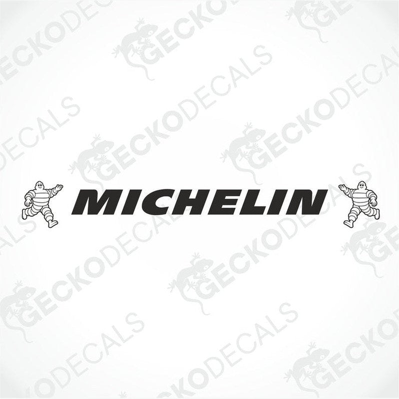 A die cut decal with the Michelin logo displayed on the front of a gray truck windshield.
