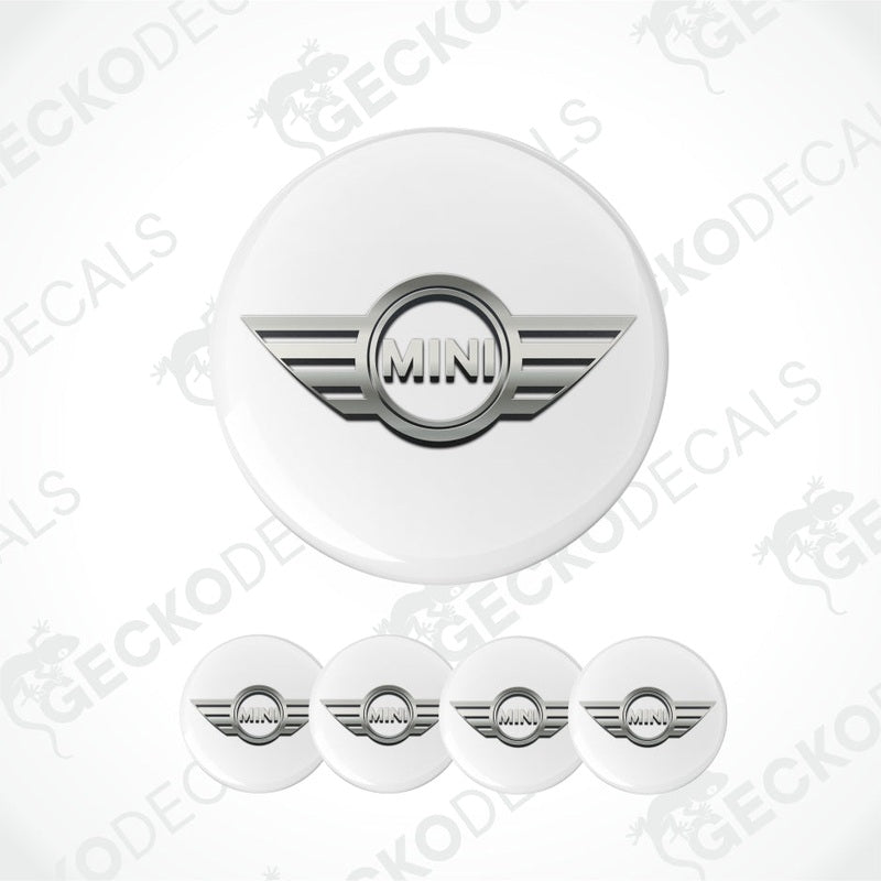Set of white circular stickers with a silver 'MINI' logo on a white background.