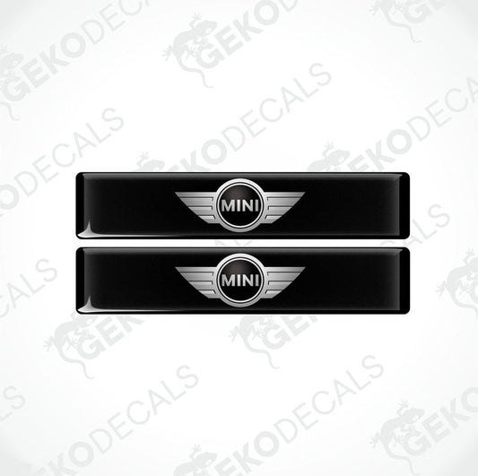 Two black, silver, and white vinyl decals with the Mini Cooper logo