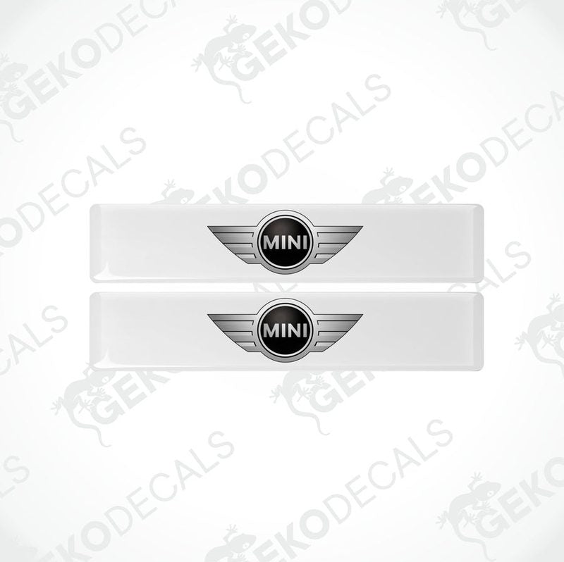 Two white, silver, and black vinyl decals with the Mini Cooper logo