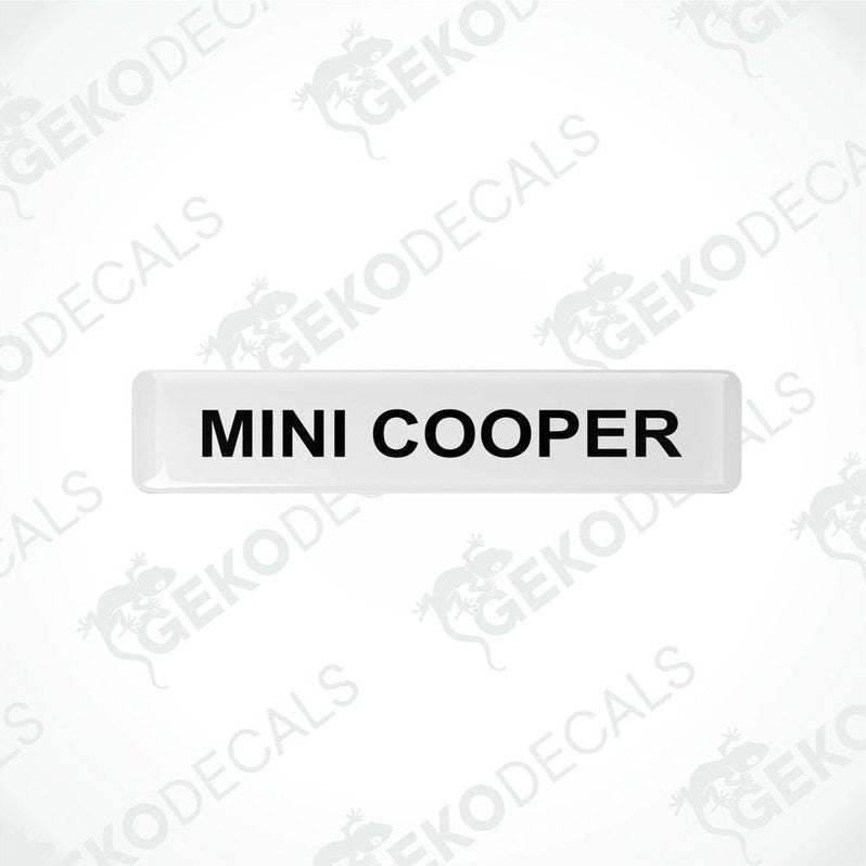 White rectangular car decals with the text 'MINI COOPER' in black.