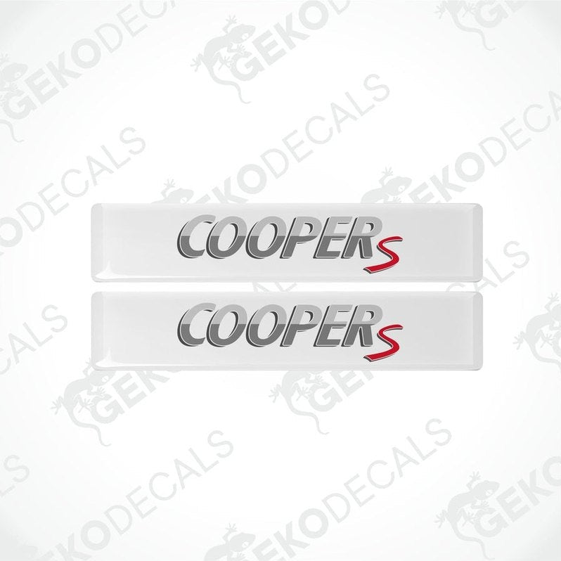 Two white vinyl decals with 'COOPERS' text in silver and red, designed for use as car stickers.