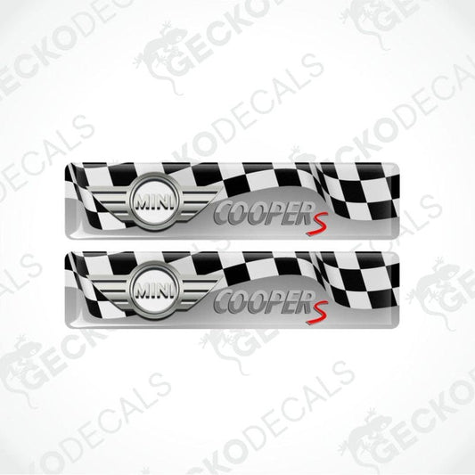two rectangles, a checkered flag in the background, a three-dimensional silver metallic Mini logo and the Cooper S lettering on top