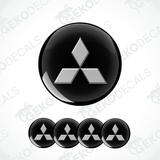 A set of black Mitsubishi car decals, with one large decal featuring the Mitsubishi logo and four smaller ones without the logo.