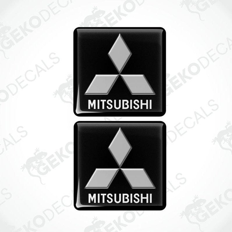 Two black vinyl stickers with a white Mitsubishi logo on each, placed against a white background.