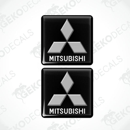 Two black vinyl stickers with a white Mitsubishi logo on each, placed against a white background.