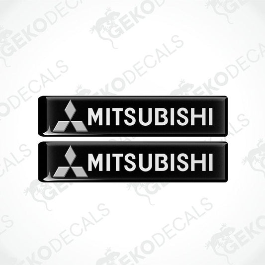 Two black vinyl stickers with the Mitsubishi brand logo on them.