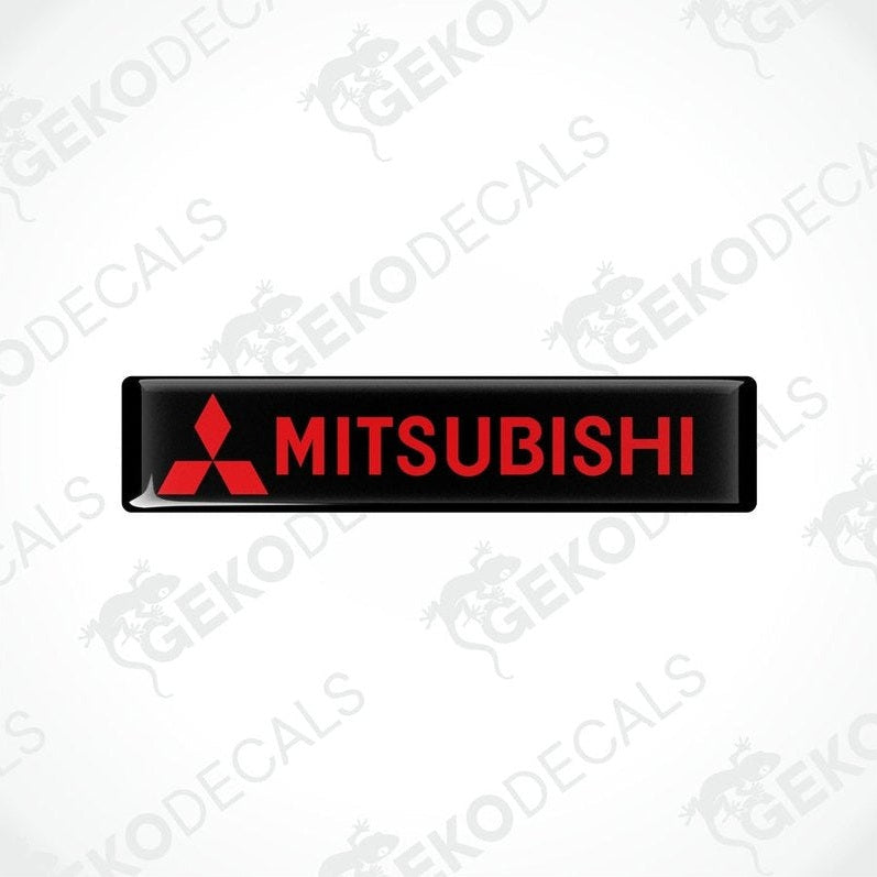 Rectangular black vinyl decals with the red Mitsubishi logo and text 'MITSUBISHI' printed in capital letters.