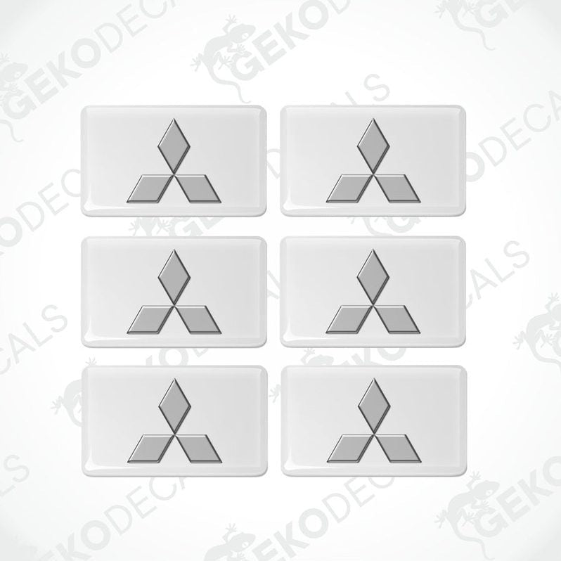 A set of six white vinyl stickers with a three-dimensional Mitsubishi logo design.