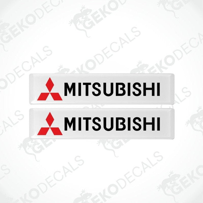 Two rectangular white vinyl decals with the Mitsubishi logo in red and black.