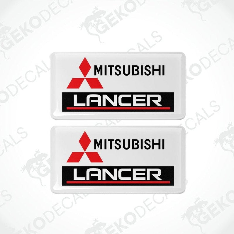 Two white vinyl stickers with red and black Mitsubishi Lancer branding.