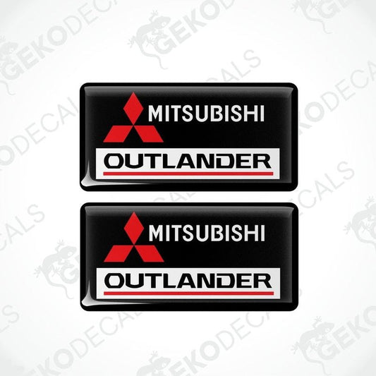 Two black vinyl stickers with red and white Mitsubishi Outlander branding.