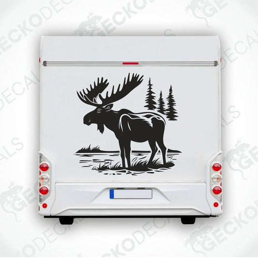 A die cut decal of a moose in a nature setting, delivered on transfer paper, shown applied on the back of a white vehicle.