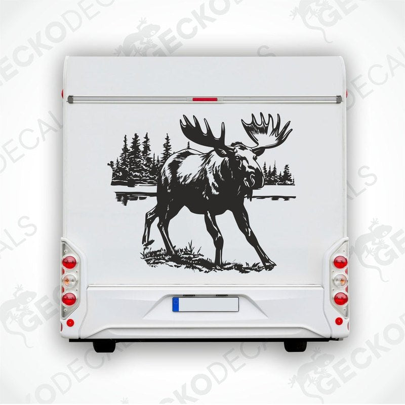 A decal of a moose on the side of a white vehicle, with a forest and lake in the background.