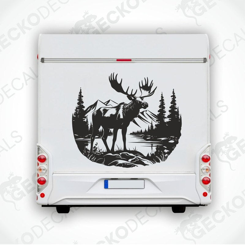 A decal of a moose in a forest and mountain setting, intended for use on a vehicle.