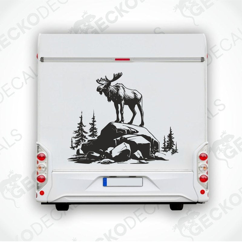 A decal of a moose standing on a rock with a forest and mountains background.