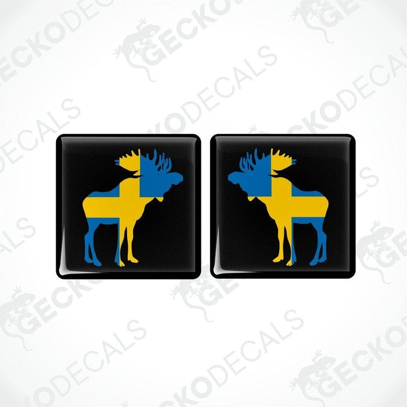 Two square car decals featuring a moose silhouette in blue and yellow on a black background.