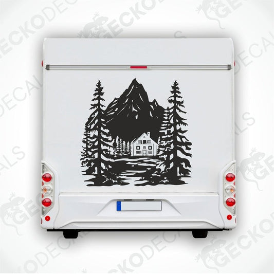 A decal of a mountain house with trees and a mountain in the background, delivered on a white vehicle.