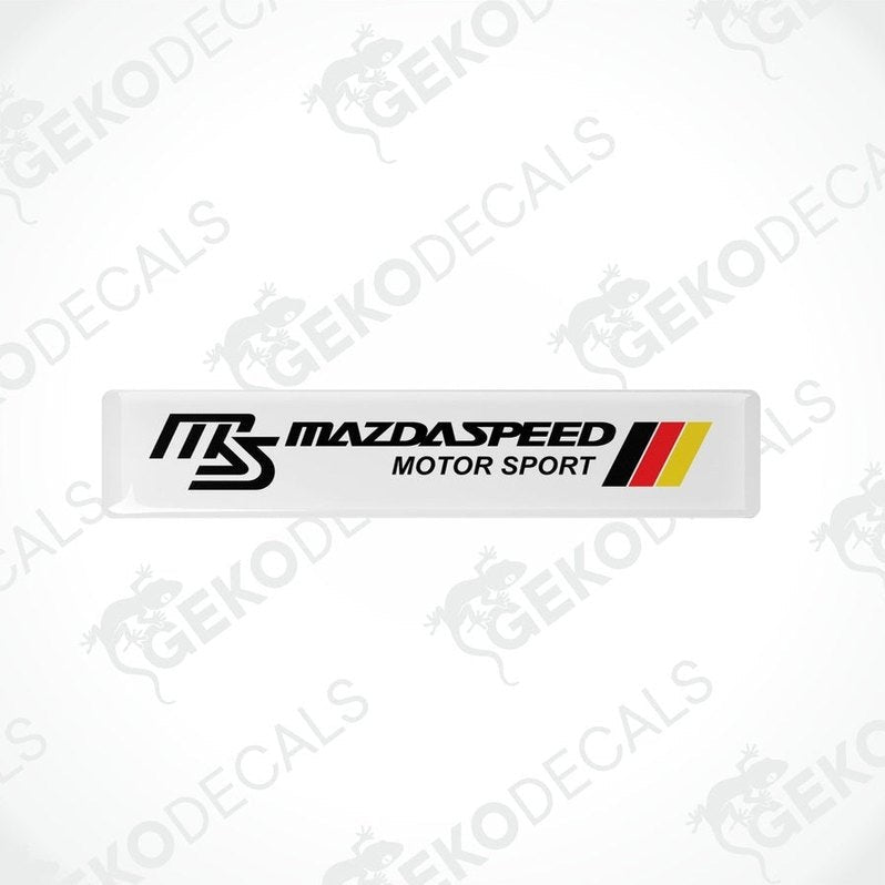  White vinyl stickers with red, black, and yellow MazdaSpeed Motor Sport logo, placed on a white background.