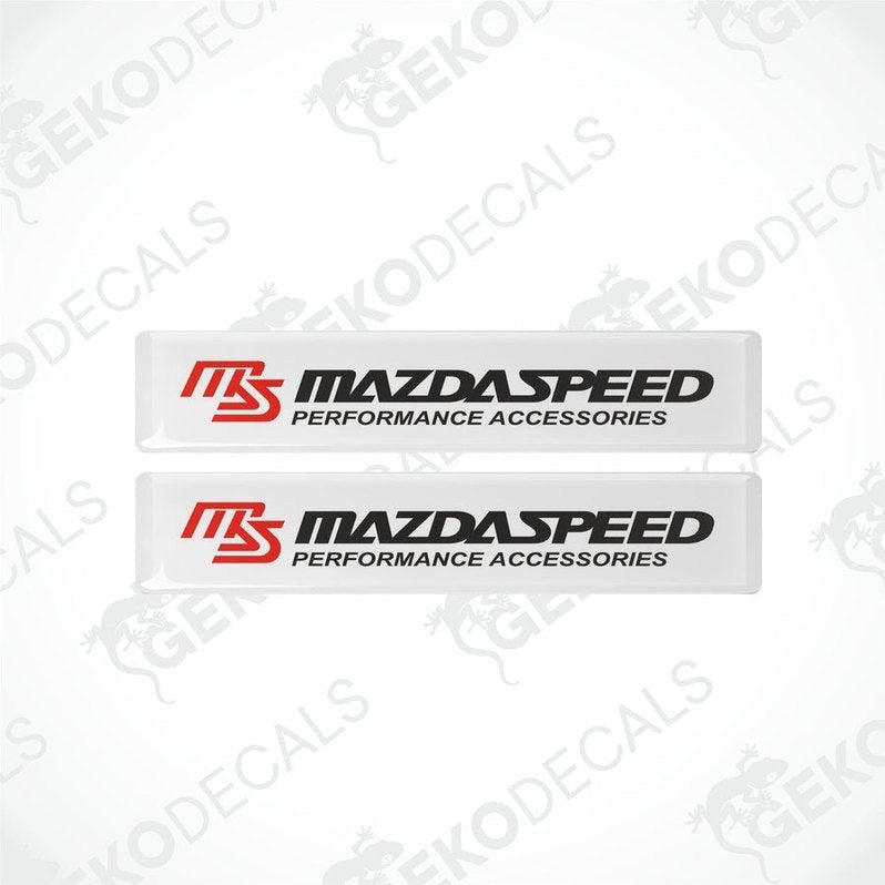 Two white vinyl stickers with the MazdaSpeed Performance Accessories logo in red and black.