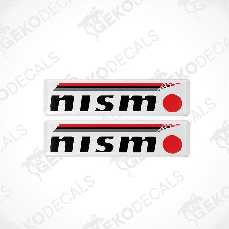 Two white, red, and black vinyl stickers with a checkered pattern and the NISMO brand logo.