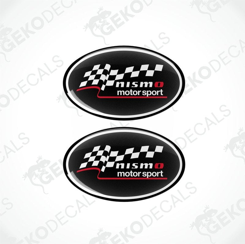 Two oval-shaped decals with a checkered flag design, featuring the text 'NISMO motor sport' in white on a black background.