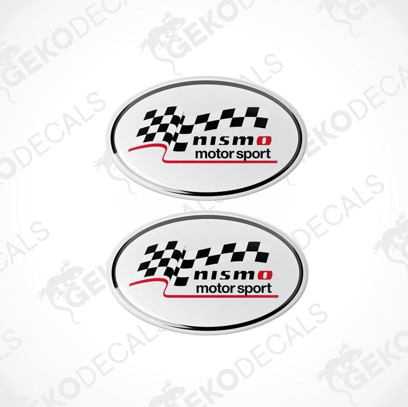 Two oval-shaped decals with a checkered flag design, featuring the text 'NISMO motor sport' in black on a white background.