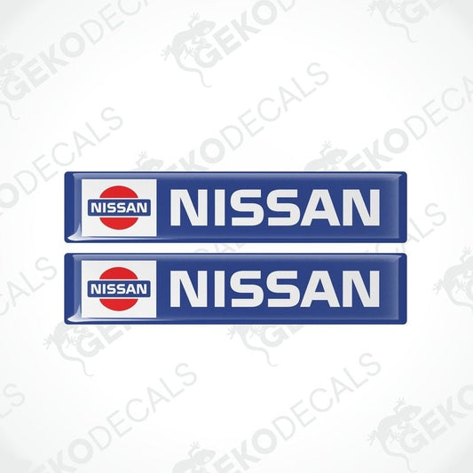 Two blue vinyl decals with the Nissan logo in white and red.